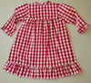 Red and white checkered dress on a white surface